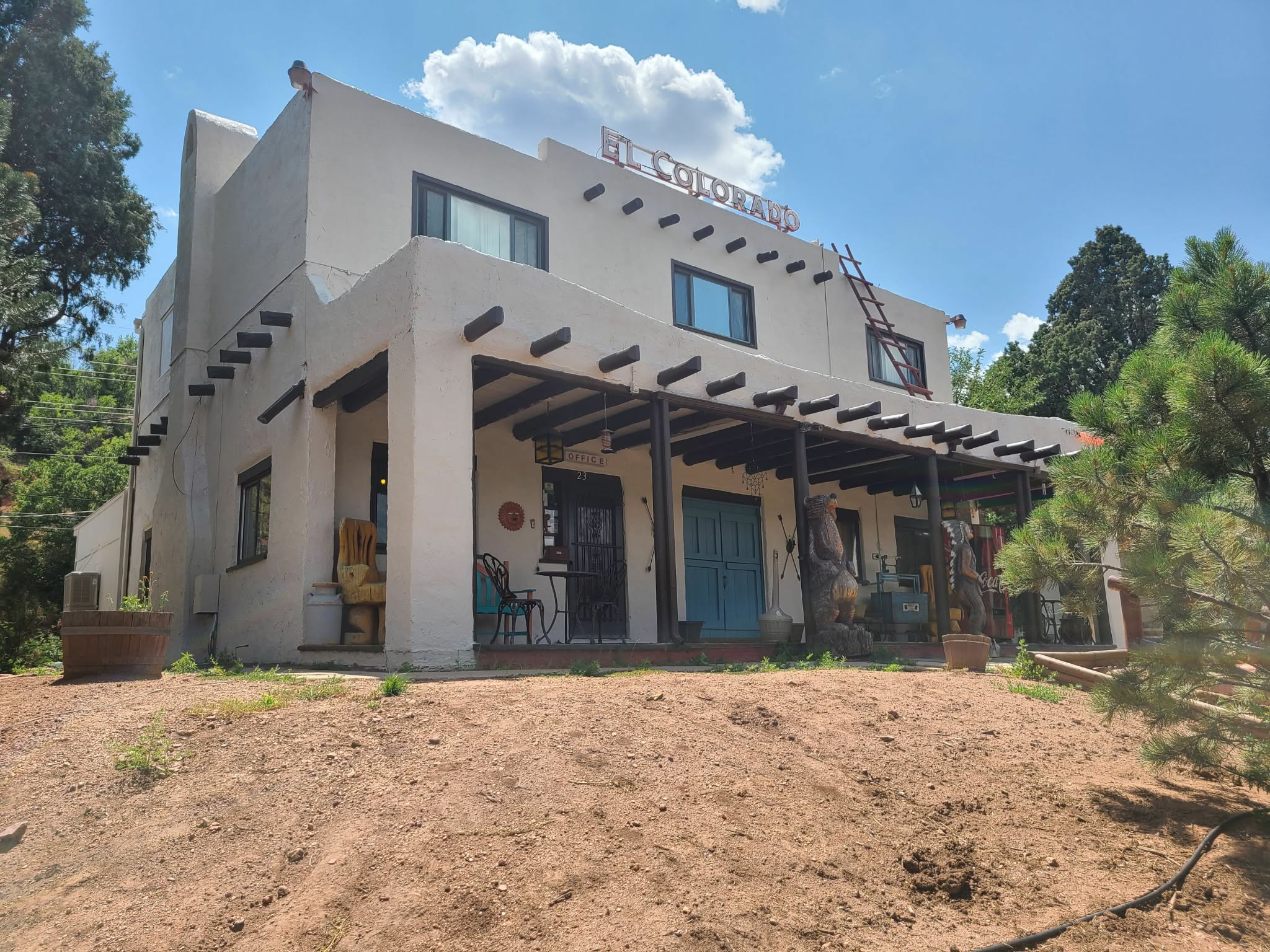 Southwestern adobe commercial building with fresh stucco paint and blue accents