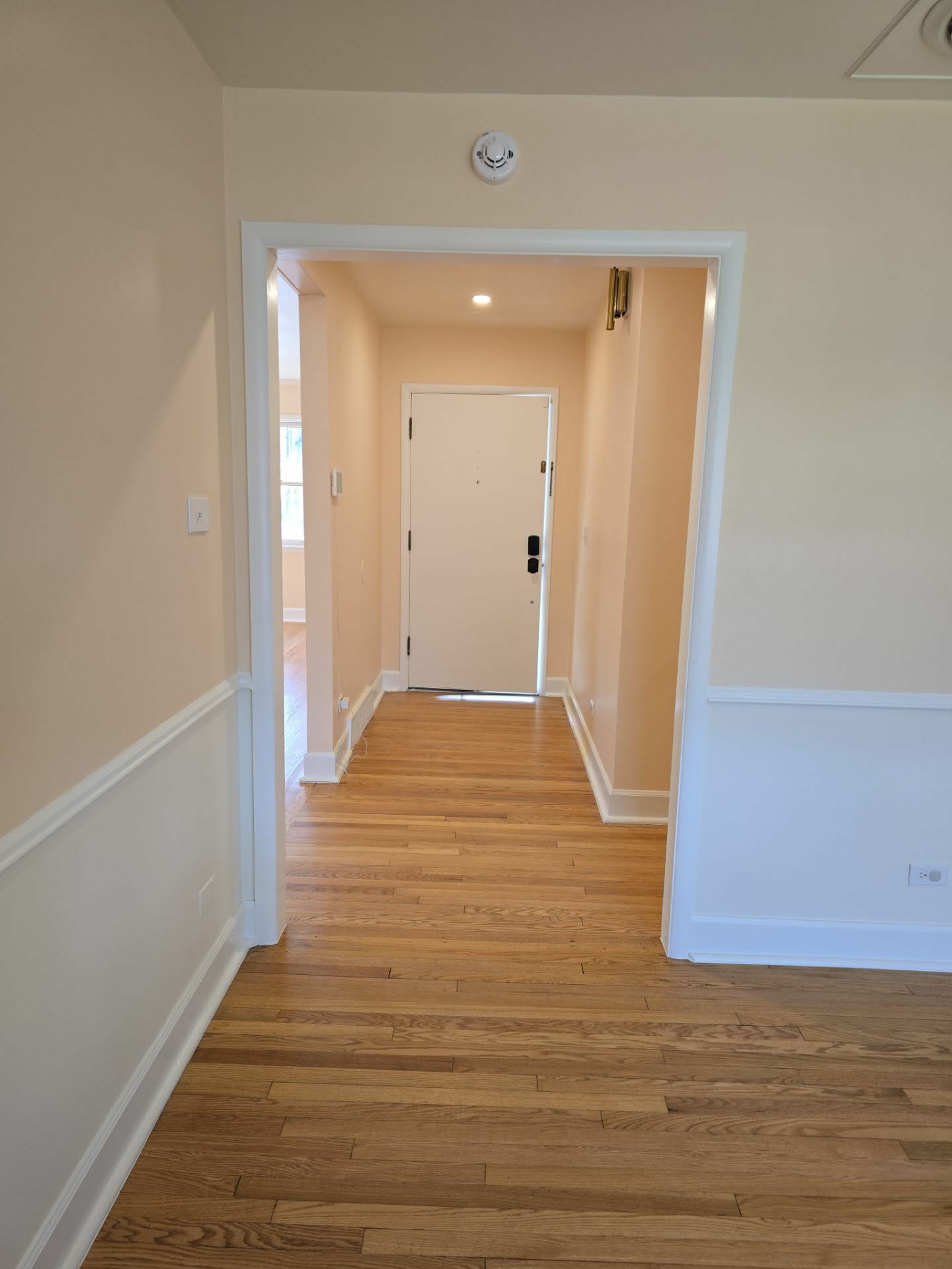 Interior archway and hallway painted soft white with wainscoting