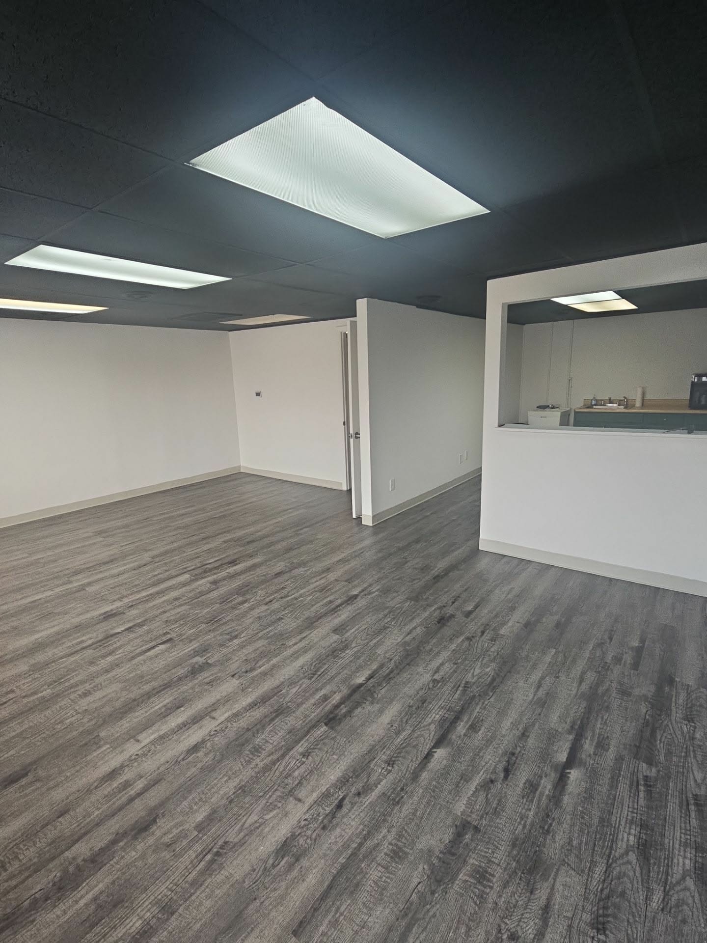 Empty commercial suite with freshly painted white walls and ceiling